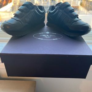 Brand new unworn toddler PRADA sneakers. Size 8 toddler.  Black leather.